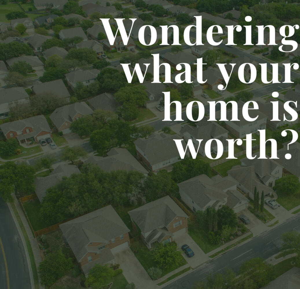 background photo of aerial view of neighborhood of houses. "Wondering What Your Home Is Worth" text overlay